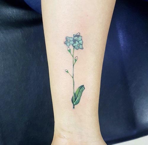 green and blue flower tattoo