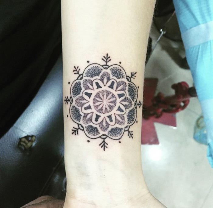 dot mandala tattoo on forearm