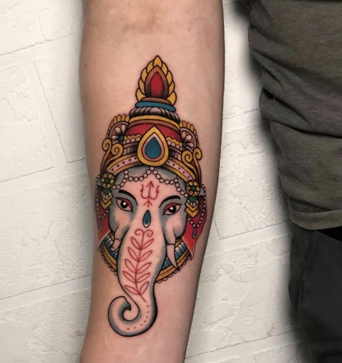 ganesha color tattoo on man forearm