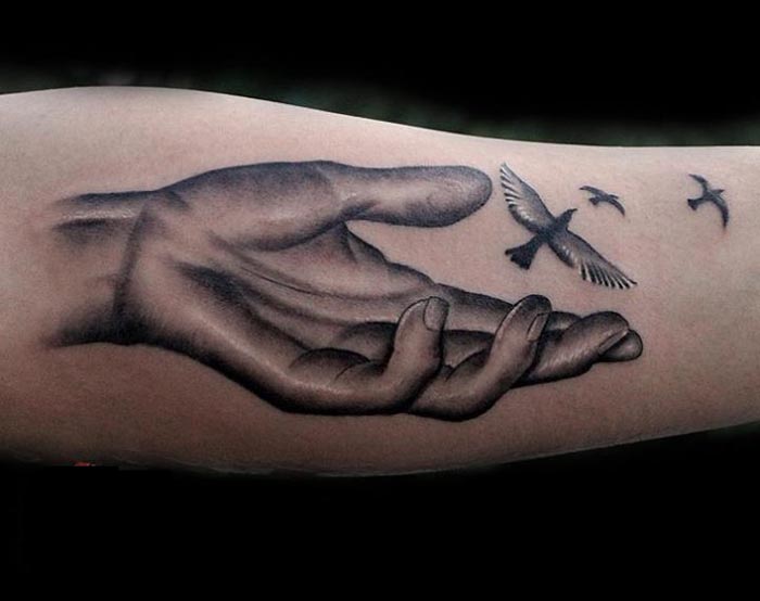 hand birds tattoo on forearm