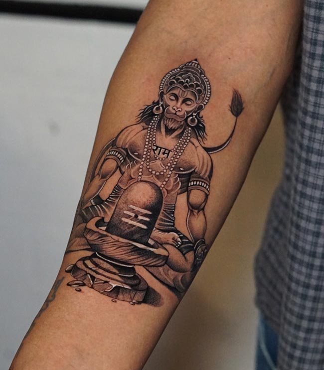 meditating hanuman in front of shiva linga tattoo man forearm