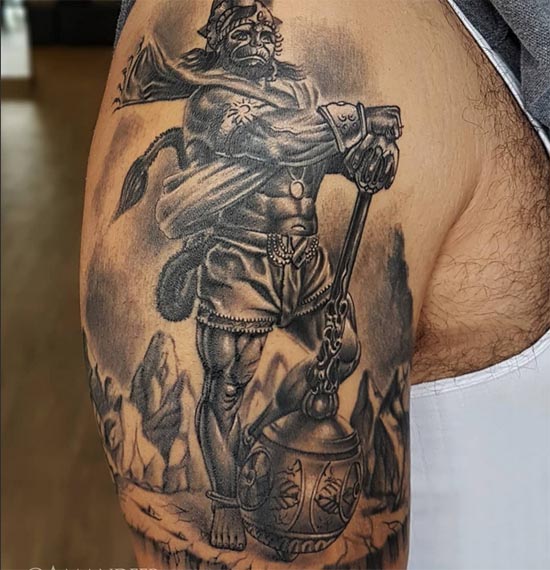 standing lord hanuman on mountain with gada tattoo design male bicep