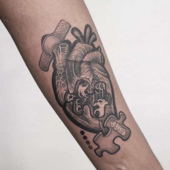 custom heart tattoo design male forearm black and grey