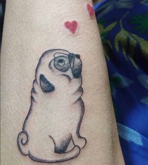dog tattoo with 2 red heart woman forearm