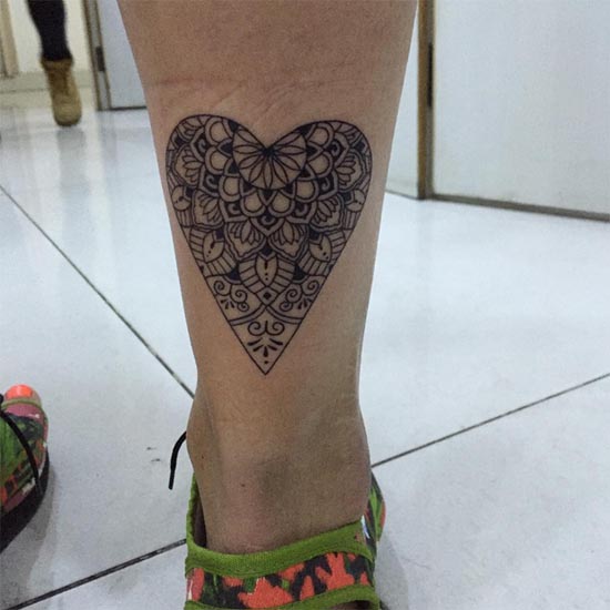 heart shaped mandala tattoo idea line work female leg calf