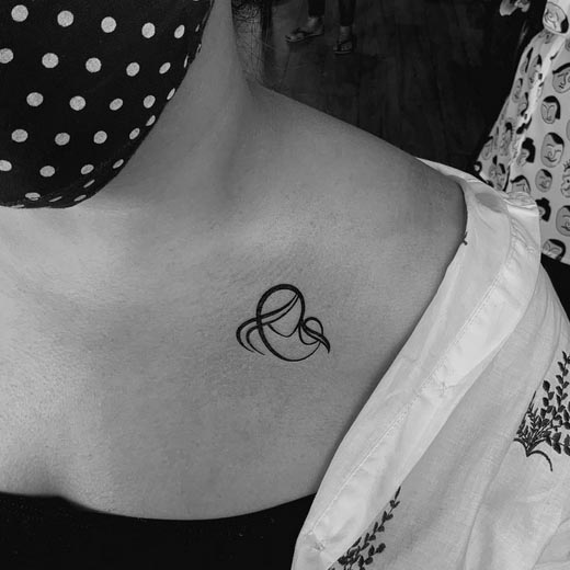 minimal heart made thick lines tattoo female collarbone