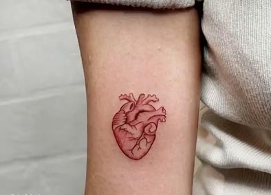 small heart tattoo red female lower bicep