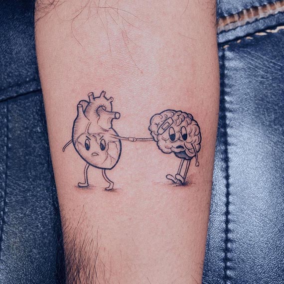 standing heart brain and holding hands tattoo male forearm