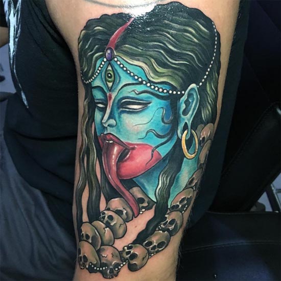 blue kali head with skulls garland tattoo design male bicep