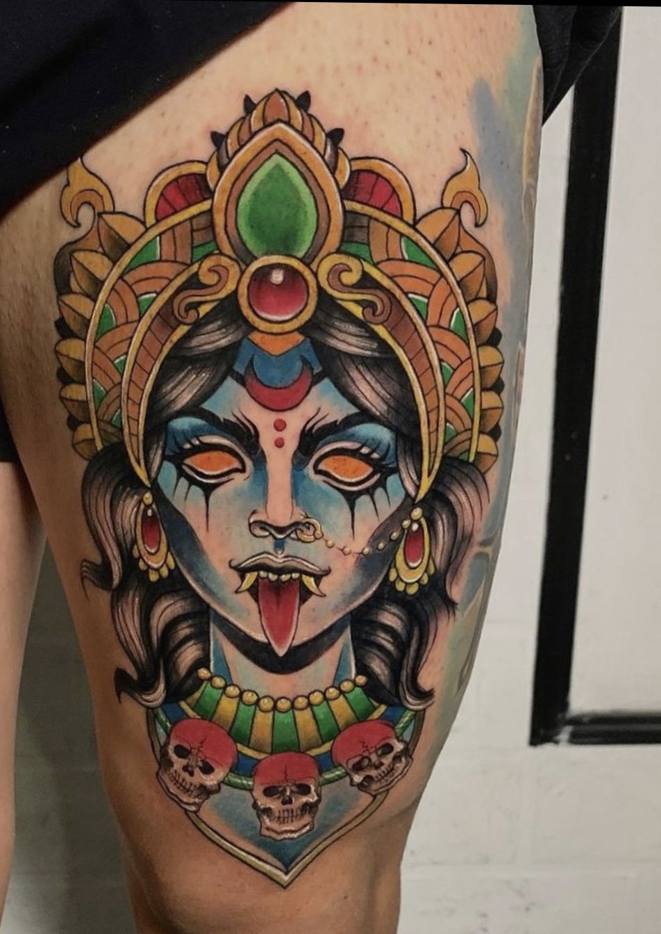 maa kali head with 3 skulls tattoo color male thigh