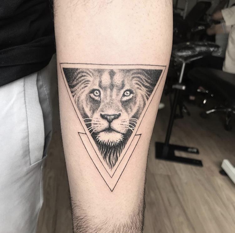 lion face in inverted triangle with another triangle male forearm