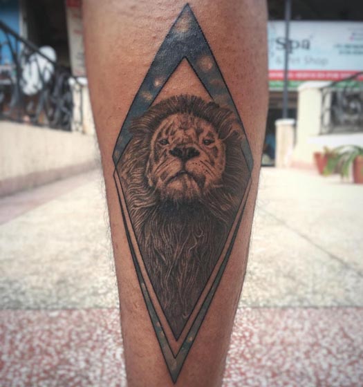lion head in vertical diamond frame tattoo design male leg calf