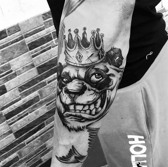 lion with crown tattoo man on hand forearm