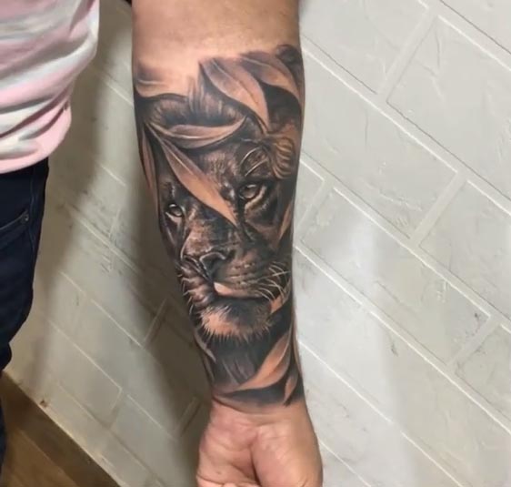 lion with leaves tattoo design male hand forearm