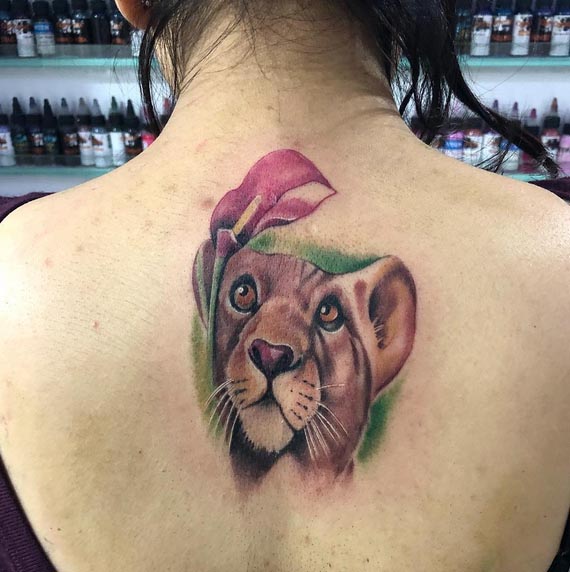 lioness head color tattoo design female back
