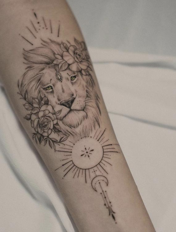 lioness head with flowers sun moon tattoo woman forearm