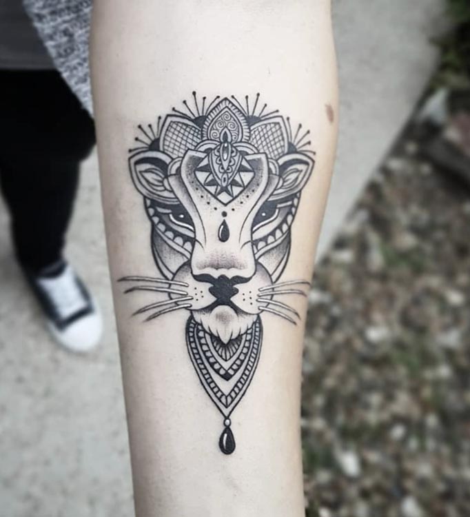 lioness head with ornamental touch woman forearm