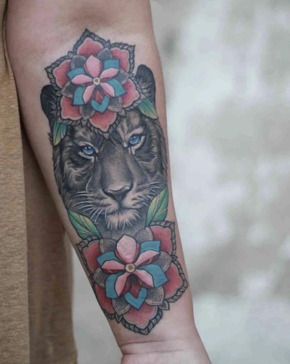 lioness with 2 flowers 1 on head 1 below chin female forearm