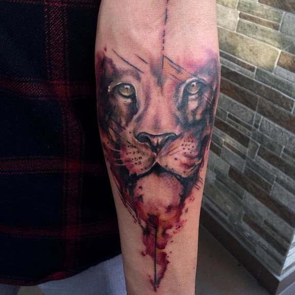watercolor lion head tattoo idea male hand forearm