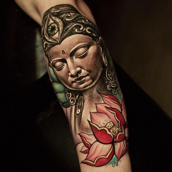 buddha face having third eye with lotus tattoo design male forearm