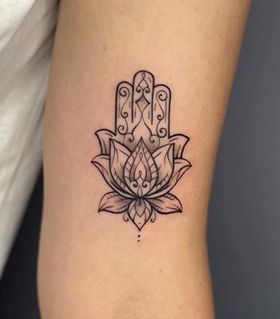 hamsa merging with mandala lotus tattoo design female bicep