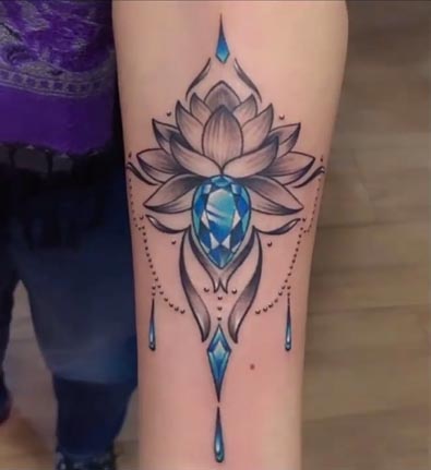 lotus blue gemstone ornamental tattoo design female forearm