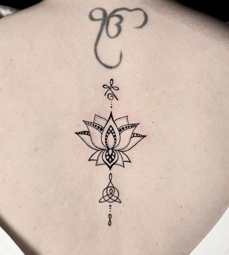 lotus linework tattoo design female spine