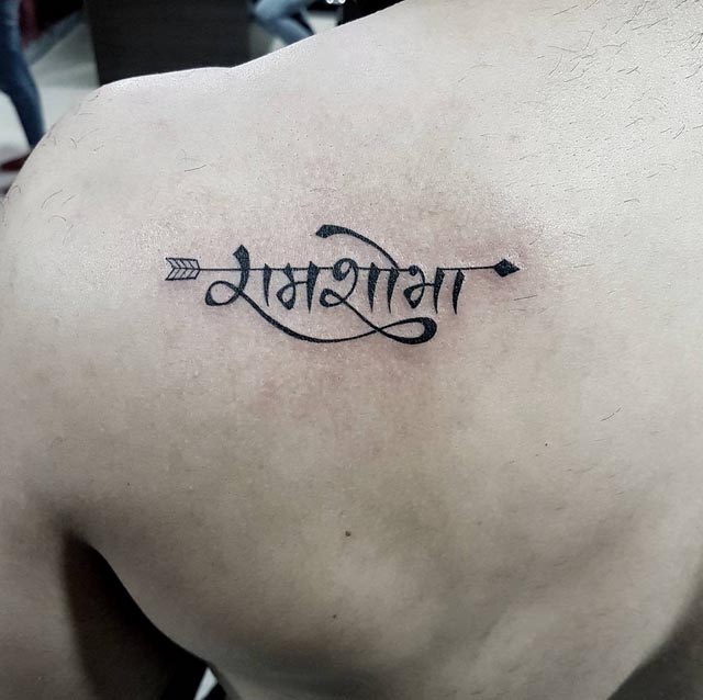 shoulder back parents name tattoo