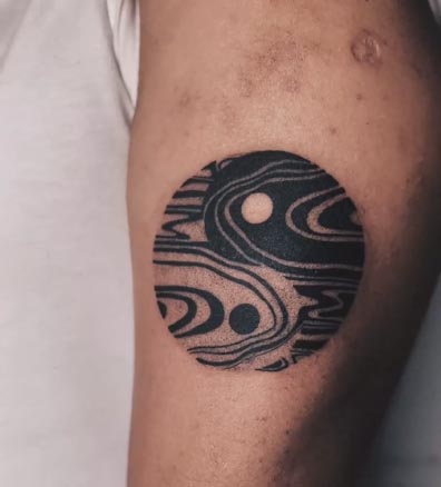 liquid flow circular shape with 2 black and white circles tattoo design male bicep