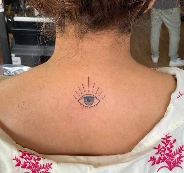 minimal eye tattoo fineline female back