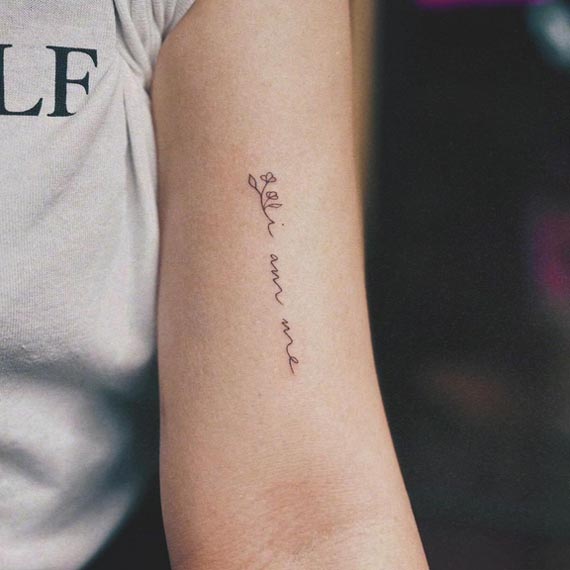 quote i am me with flower small tattoo female bicep