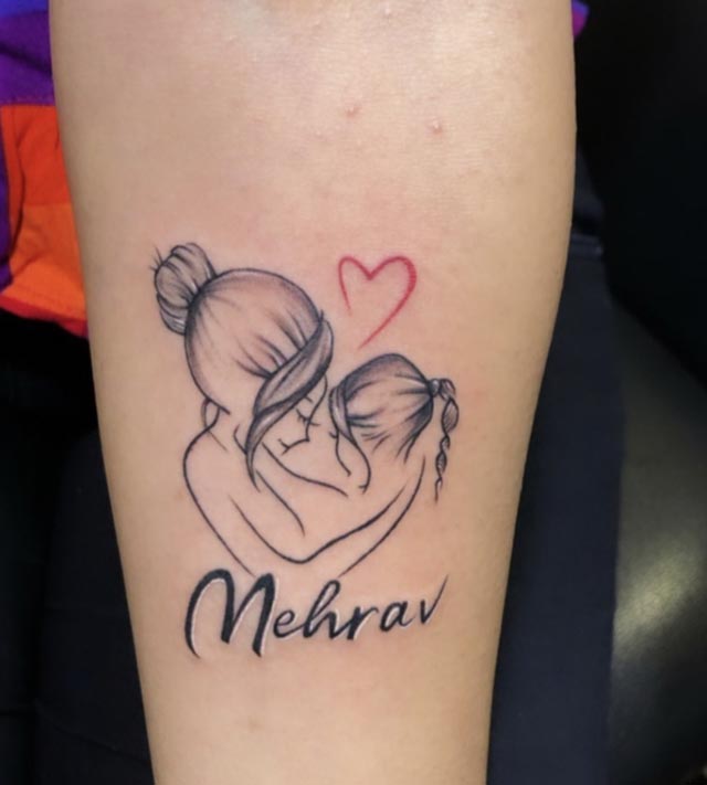 mother cradles her daughter tattoo