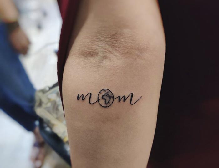 simple mom tattoo with world in it