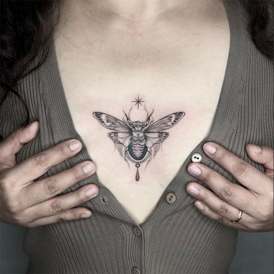 cicada moth tattoo design female sternum black and grey