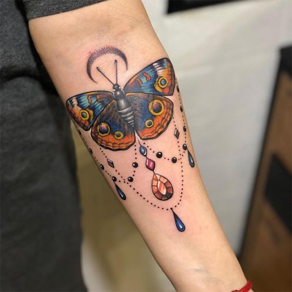 moth ornamental tattoo color female hand forearm