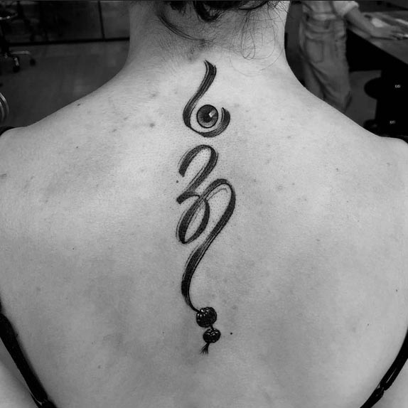 eye om rudraksha -bead tattoo design idea female back black and grey