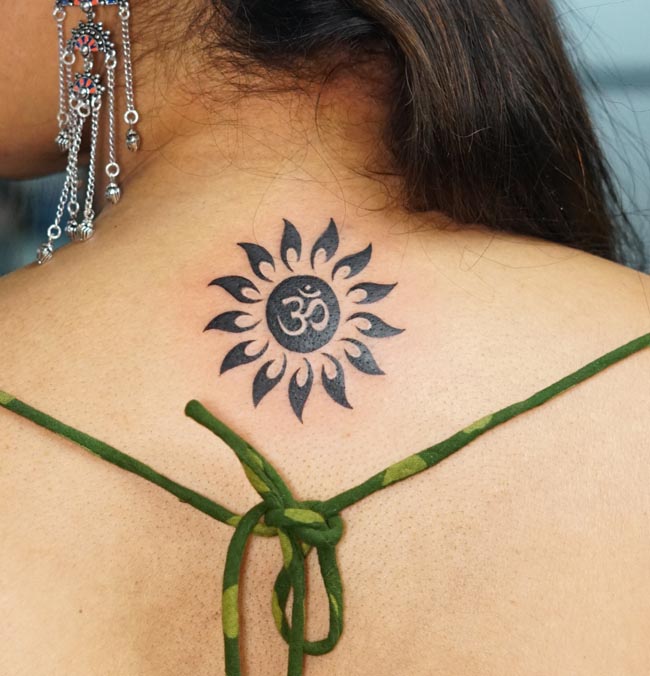 om in center of sun tattoo blackwork female back