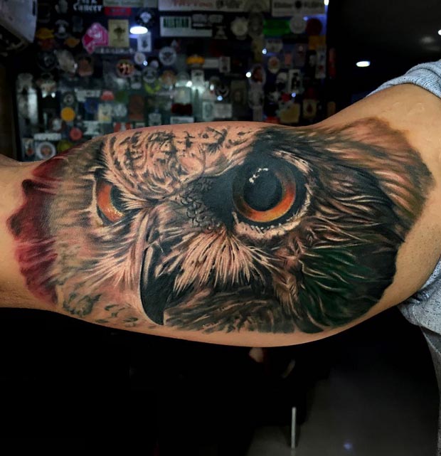 big owl face with orange eyes tattoo design male inner bicep