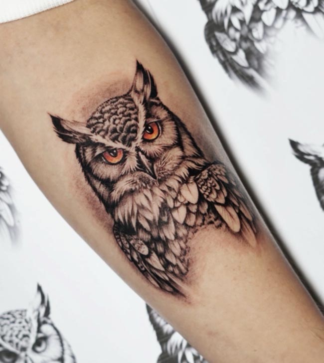 owl head orange eyes tattoo realistic male forearm