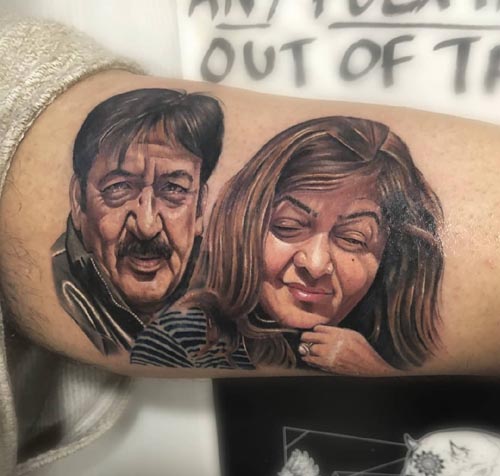parents portrait tattoo on arm