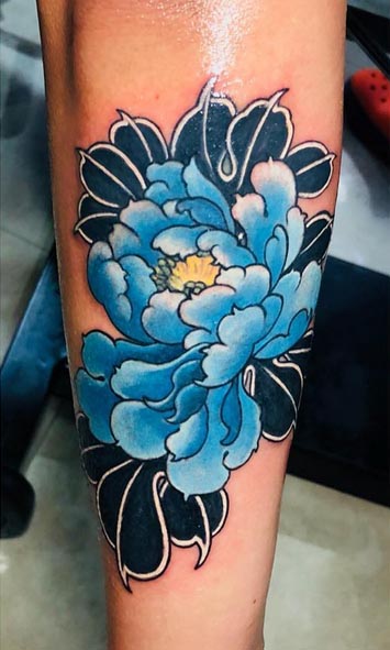 blue peony tattoo design on hand forearm meaning