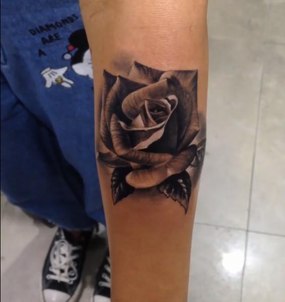 rose with leaves tattoo design female upper forearm