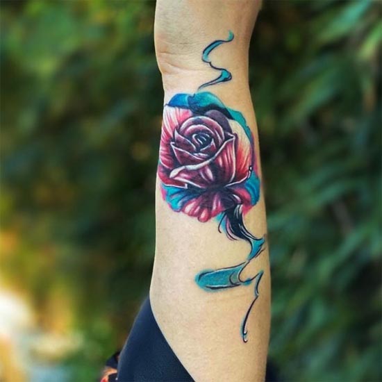 color rose with blue flowing water tattoo idea female hand forearm
