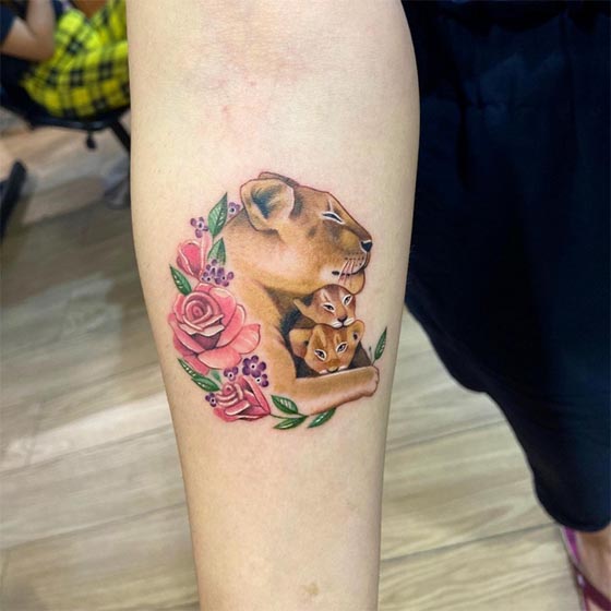 lioness with her two cubs rose flower tattoo color female hand forearm