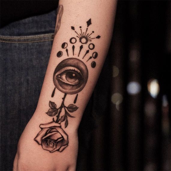 rose and eye tattoo design female hand forearm