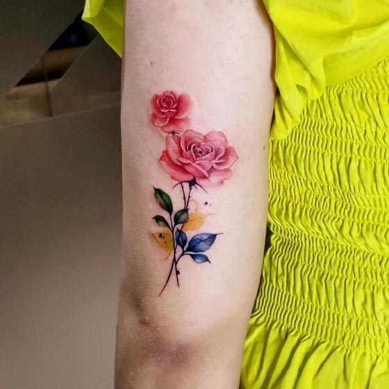 rose tattoo semi realistic abstract female outer bicep
