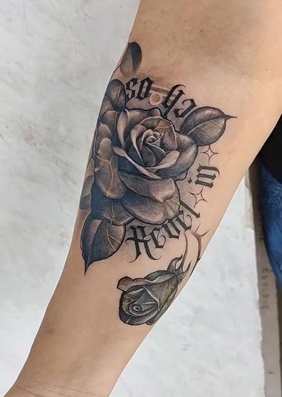 rose thorns around arm tattoo design female