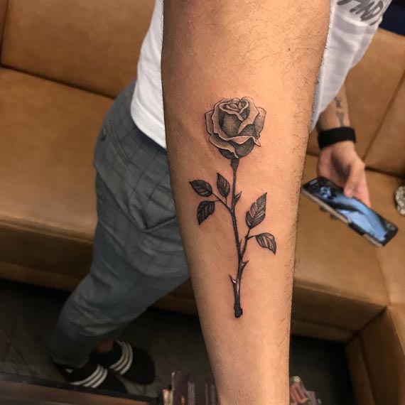 rose with leaves tattoo design male hand forearm black and grey