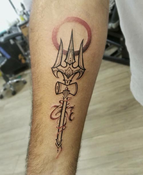 black and red trishul tattoo on Forearm