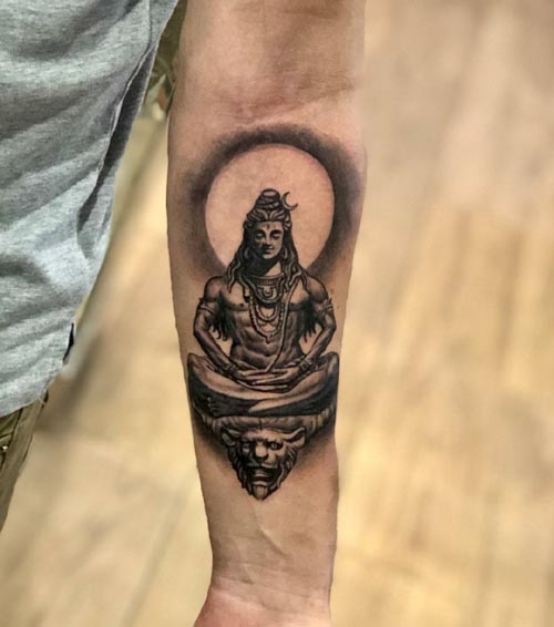 small meditating shiva tattoo on Forearm